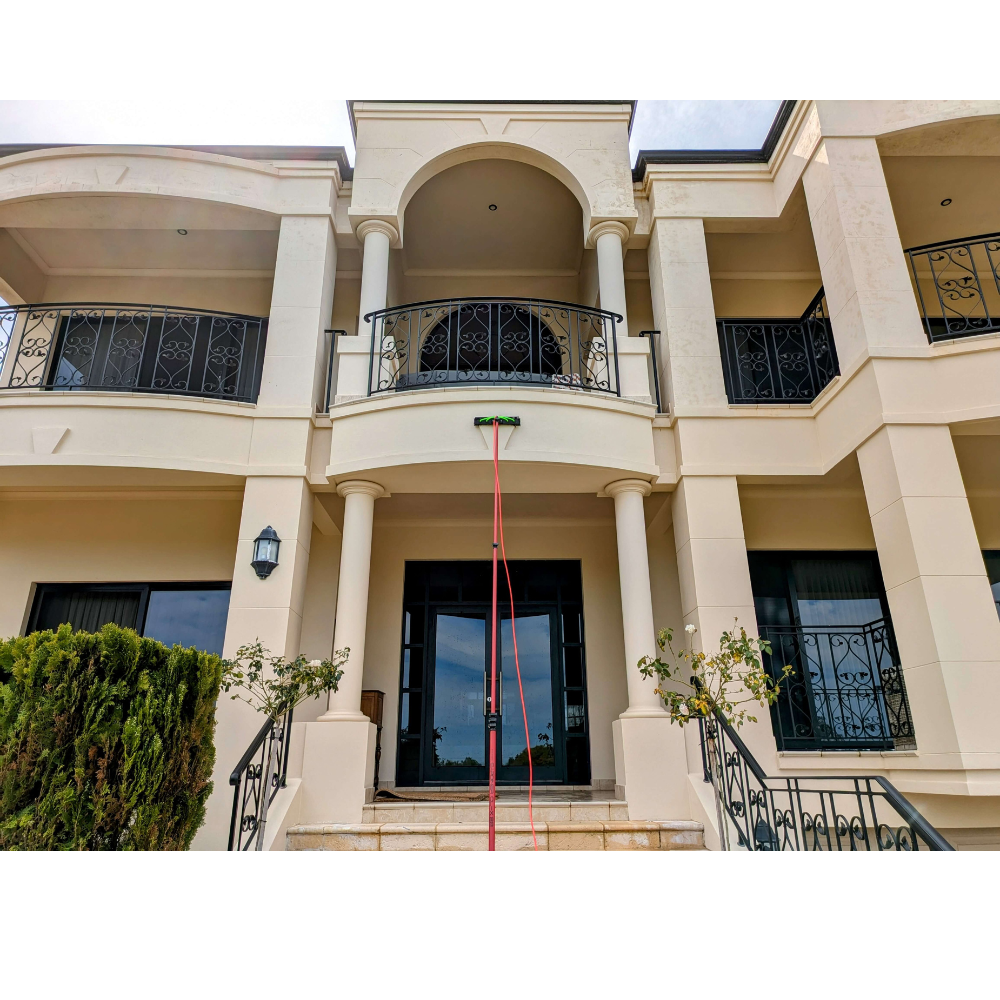A sparkling clean window reflecting a clear blue sky, demonstrating the importance of window cleaning.